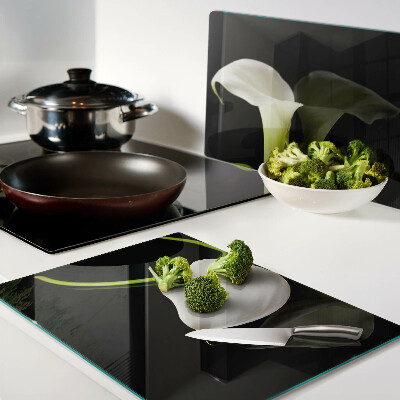 Tagliere in vetro con motivo a giglio su sfondo nero