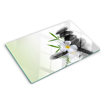 Tagliere in vetro temperato con motivo di fiori e pietre sull'acqua