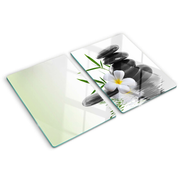 Tagliere in vetro temperato con motivo di fiori e pietre sull'acqua