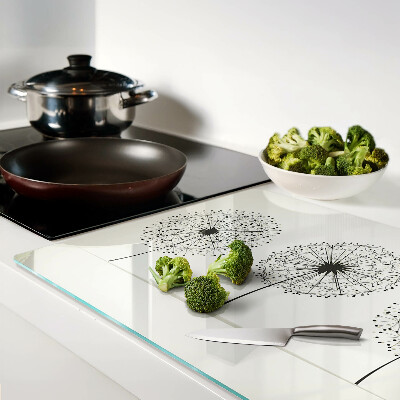 Tagliere in vetro temperato con motivo di denti di leone su sfondo bianco