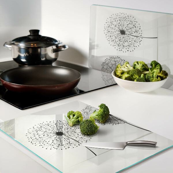 Tagliere in vetro temperato con motivo di denti di leone su sfondo bianco