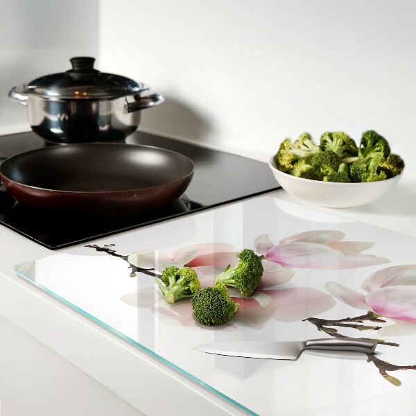 Tagliere in vetro con decorazione con fiori di magnolia su ramo