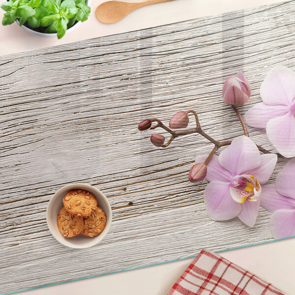 Tagliere in vetro temperato con motivo di orchidee su sfondo di legno