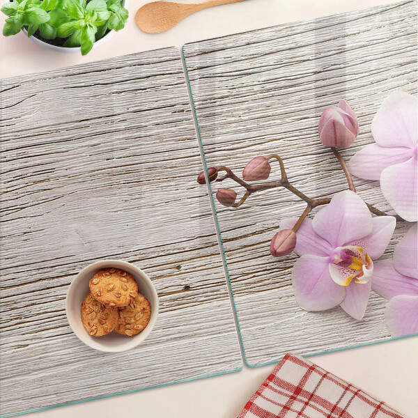 Tagliere in vetro temperato con motivo di orchidee su sfondo di legno