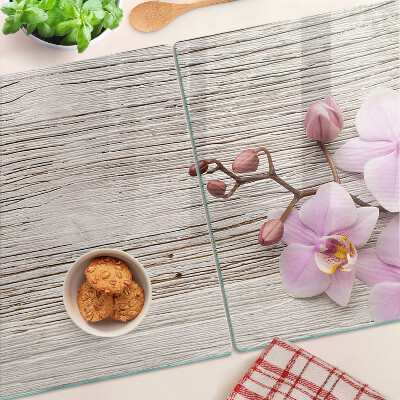 Tagliere in vetro temperato con motivo di orchidee su sfondo di legno