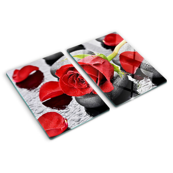 Tagliere in vetro temperato con motivo rosa sulle pietre e gocce d'acqua