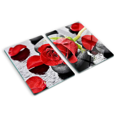 Tagliere in vetro temperato con motivo rosa sulle pietre e gocce d'acqua