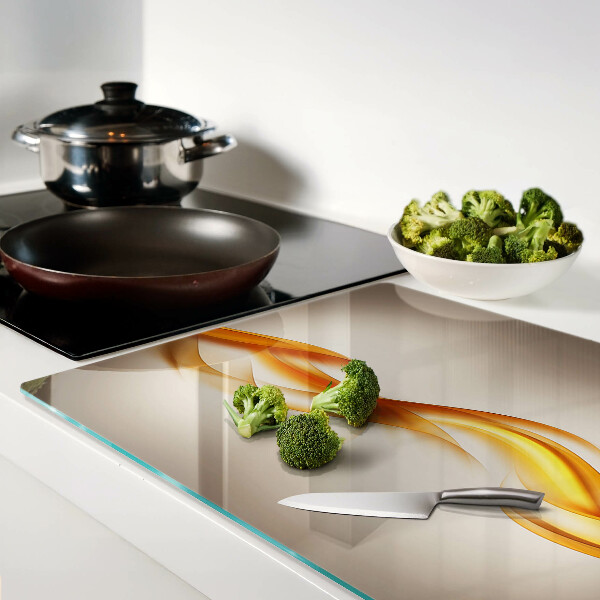 Tagliere in vetro temperato con decorazione a onde nei toni dell'oro