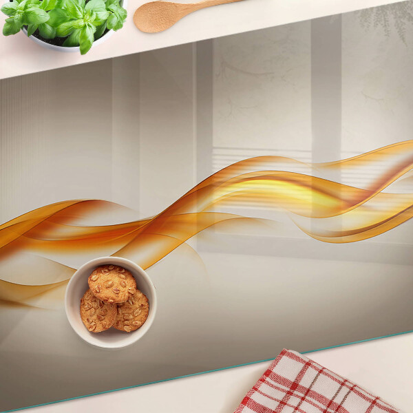 Tagliere in vetro temperato con decorazione a onde nei toni dell'oro