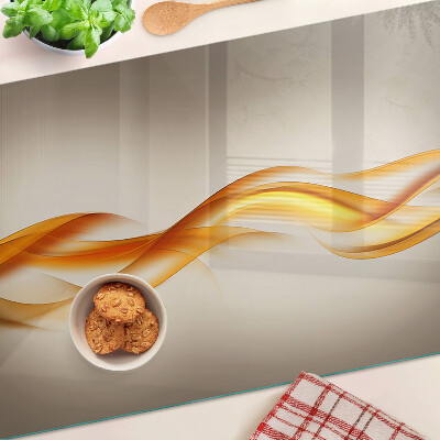 Tagliere in vetro temperato con decorazione a onde nei toni dell'oro