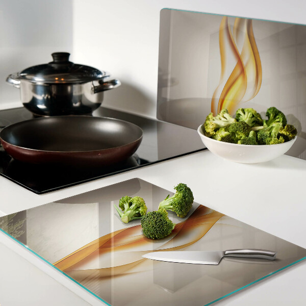 Tagliere in vetro temperato con decorazione a onde nei toni dell'oro