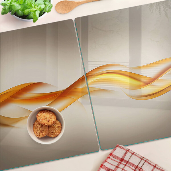 Tagliere in vetro temperato con decorazione a onde nei toni dell'oro