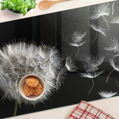 Tagliere in vetro temperato con motivo di denti di leone su sfondo nero