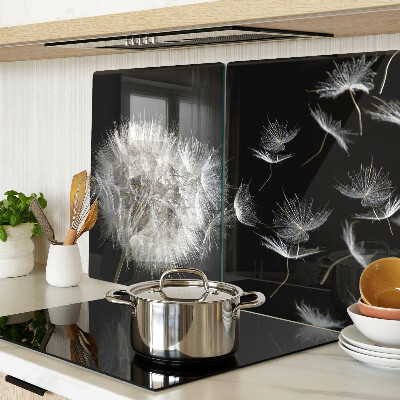 Tagliere in vetro temperato con motivo di denti di leone su sfondo nero