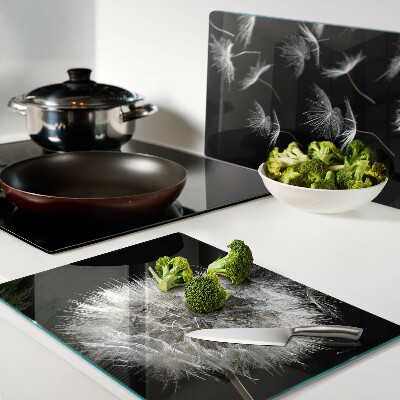 Tagliere in vetro temperato con motivo di denti di leone su sfondo nero