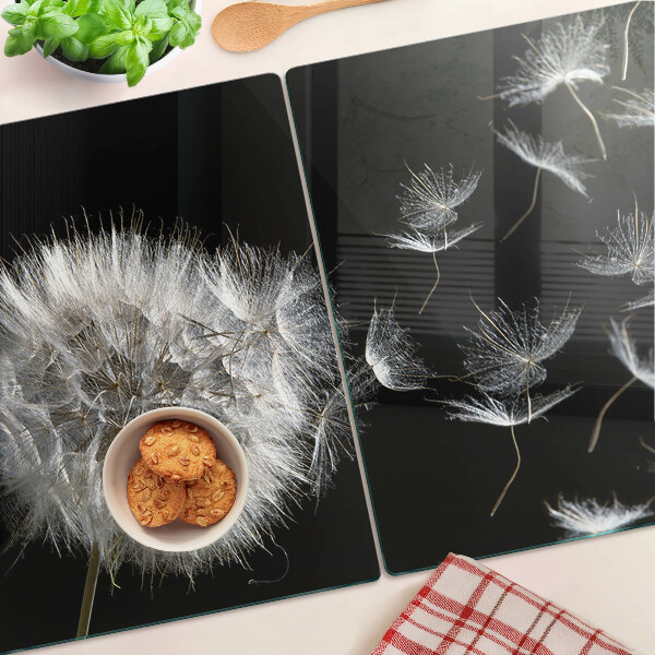 Tagliere in vetro temperato con motivo di denti di leone su sfondo nero