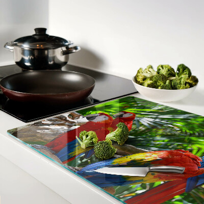 Tagliere in vetro con stampa raffigurante pappagalli in un ambiente tropicale