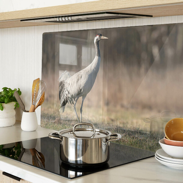 Tagliere in vetro con stampa di una gru su sfondo paesaggistico