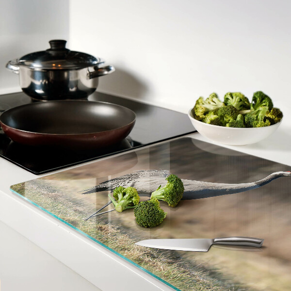 Tagliere in vetro con stampa di una gru su sfondo paesaggistico