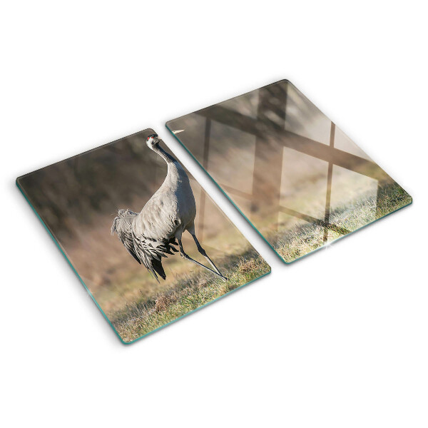 Tagliere in vetro con stampa di una gru su sfondo paesaggistico