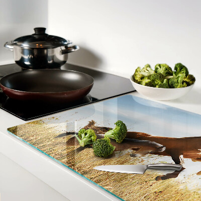 Tagliere in vetro con stampa di cavalli che pascolano al sole