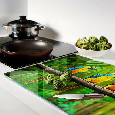 Tagliere in vetro temperato con stampa di pappagalli su un ramo in stile tropicale