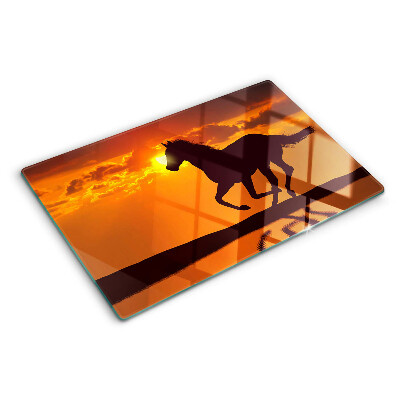 Tagliere in vetro con stampa di un cavallo davanti al sole al tramonto