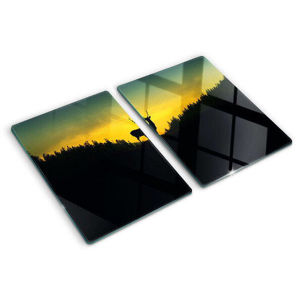 Tagliere in vetro temperato con disegno di un cervo su sfondo di sole al tramonto
