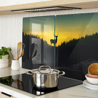 Tagliere in vetro temperato con disegno di un cervo su sfondo di sole al tramonto