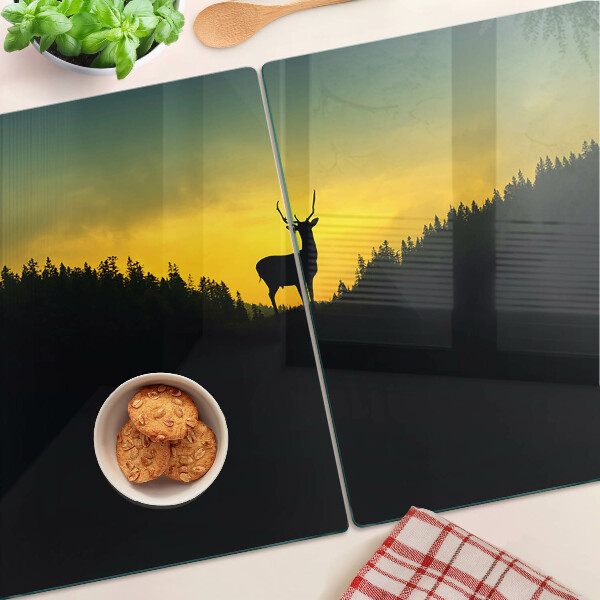 Tagliere in vetro temperato con disegno di un cervo su sfondo di sole al tramonto