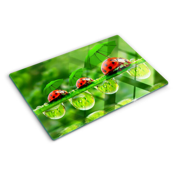 Tagliere in vetro temperato con motivo di coccinelle sulle foglie e gocce d'acqua
