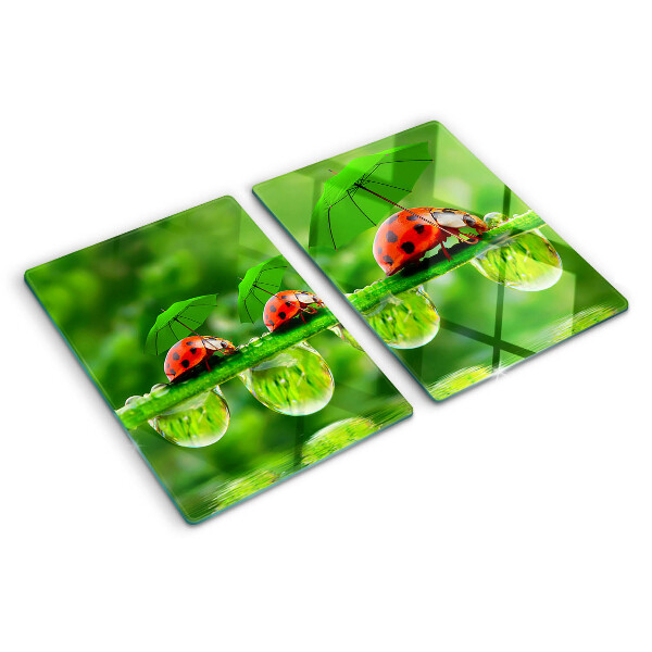 Tagliere in vetro temperato con motivo di coccinelle sulle foglie e gocce d'acqua