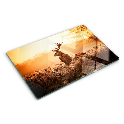 Tagliere in vetro con decorazione di un cervo sullo sfondo del tramonto