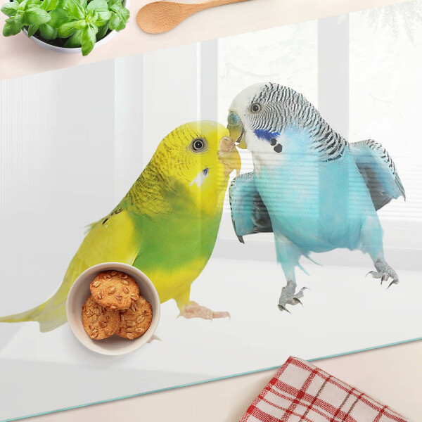 Tagliere in vetro temperato con decorazione di pappagalli nei toni del giallo e del blu