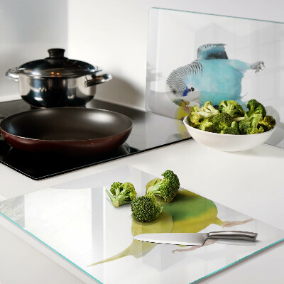 Tagliere in vetro temperato con decorazione di pappagalli nei toni del giallo e del blu