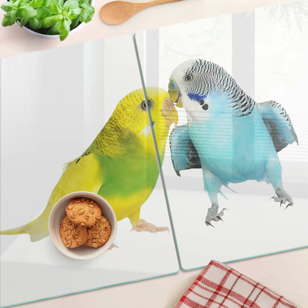 Tagliere in vetro temperato con decorazione di pappagalli nei toni del giallo e del blu