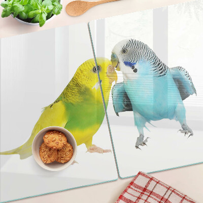 Tagliere in vetro temperato con decorazione di pappagalli nei toni del giallo e del blu