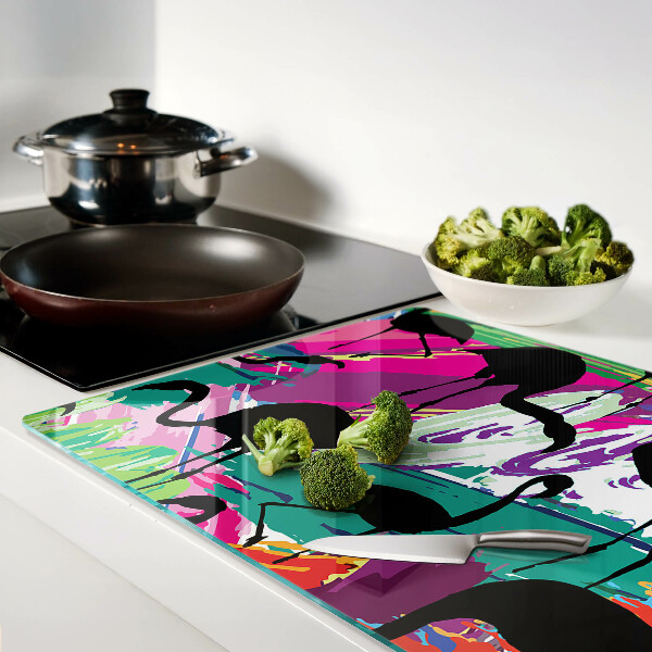 Tagliere in vetro con decorazione di fenicotteri su sfondo colorato