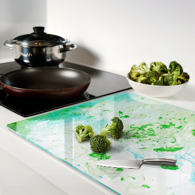 Tagliere in vetro con motivo a vortici astratti nei toni del verde e del blu