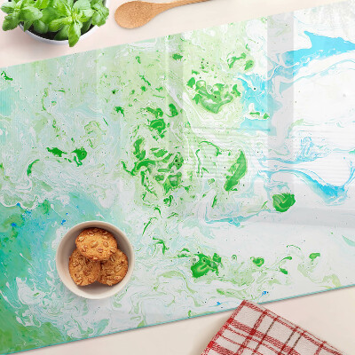 Tagliere in vetro con motivo a vortici astratti nei toni del verde e del blu