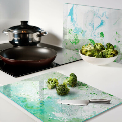 Tagliere in vetro con motivo a vortici astratti nei toni del verde e del blu