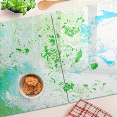 Tagliere in vetro con motivo a vortici astratti nei toni del verde e del blu