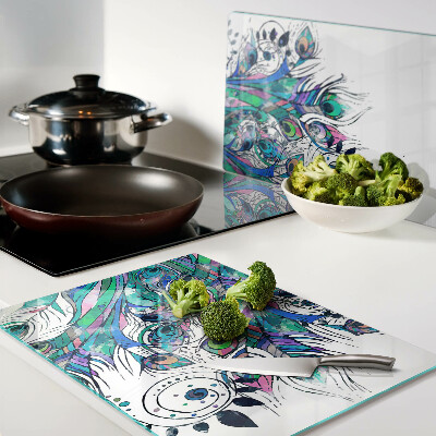 Tagliere in vetro temperato con motivo di piume di pavone nei toni del verde e del blu