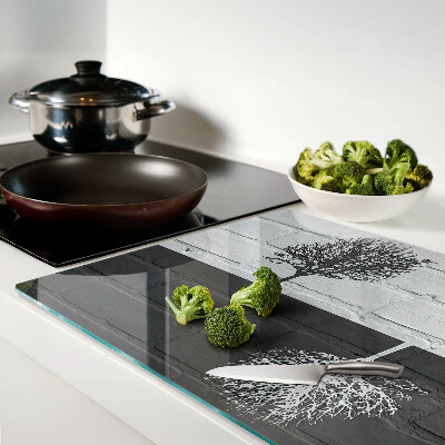 Tagliere in vetro con stampa di un albero su sfondo di mattoni