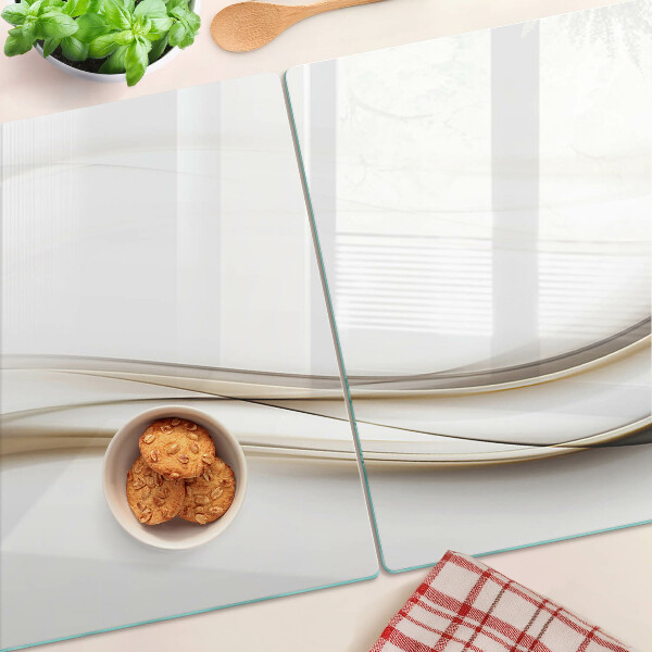 Tagliere in vetro temperato con motivo a onde astratte nei toni del beige