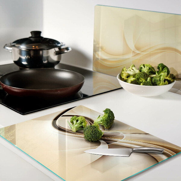 Tagliere in vetro con stampa a onde astratte nei toni del beige