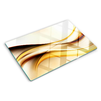 Tagliere in vetro temperato con motivo di onde astratte nei toni dell'oro