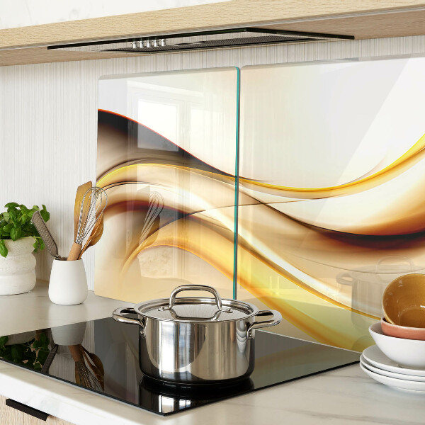 Tagliere in vetro temperato con motivo di onde astratte nei toni dell'oro