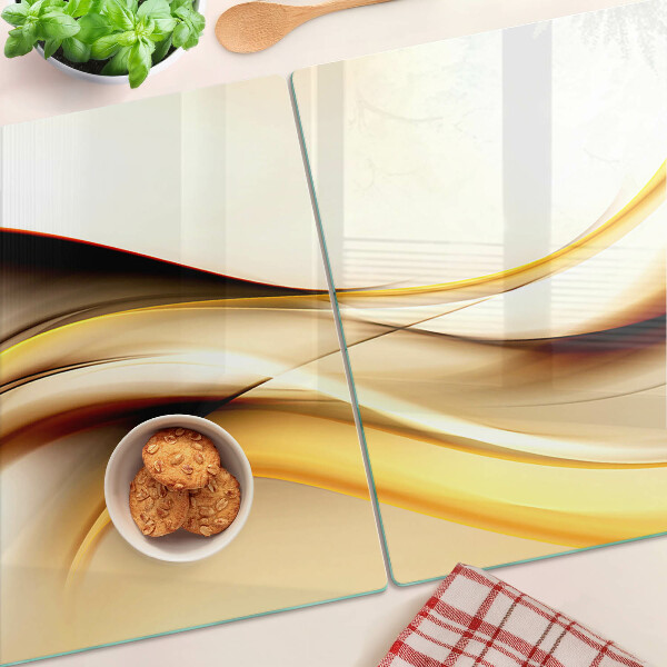 Tagliere in vetro temperato con motivo di onde astratte nei toni dell'oro