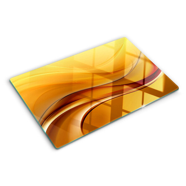 Tagliere in vetro con motivo a onde nei toni dell'oro